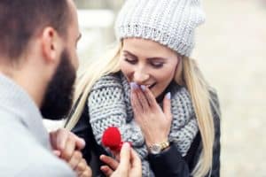 Man proposing to woman wearing scarf