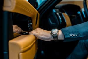 Man Getting Out of Car Wearing a Luxury Watch