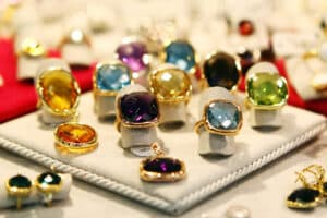 an assortment of rings on display with different colored jewels