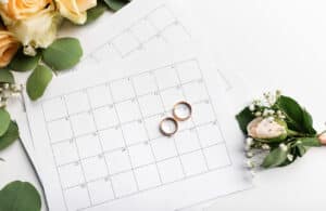 calendar with wedding rings and flowers representing wedding planning with 2023 wedding trends