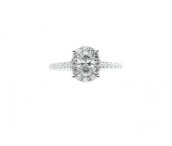 Lady’s White 14 Karat Halo Engagement Ring Size 6.75 With One 0.60Ct Oval H I1 Diamond And 0.50Tw Round G Vs1 Diamonds