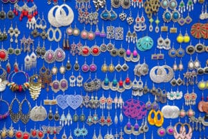 various clean earrings placed next to each other on blue background